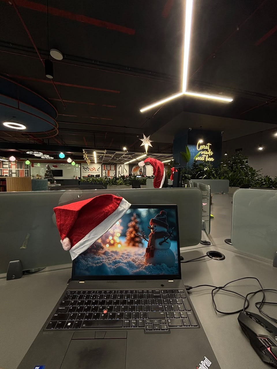 A laptop and workspace at the Geeky Wolf office decorated for Christmas