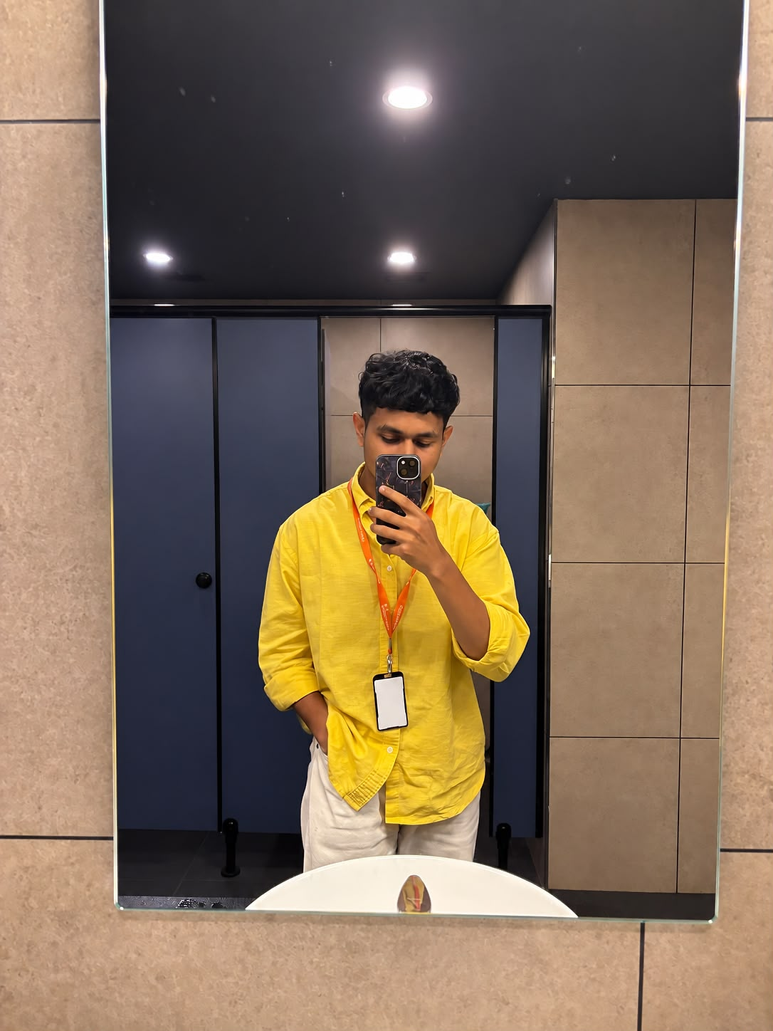 Nabeel wearing a yellow shirt and office lanyard at Geeky Wolf
