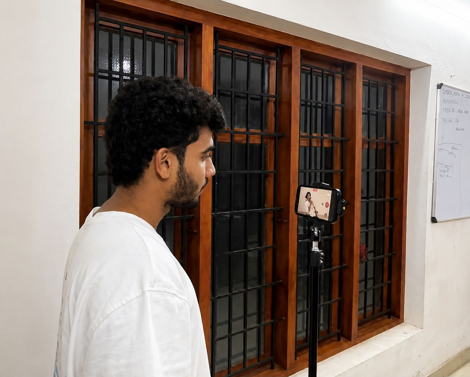 A team member recording a video on a phone mounted on a tripod